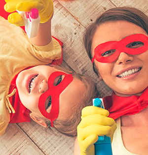 woman and child sitting on the floor wearing red masks